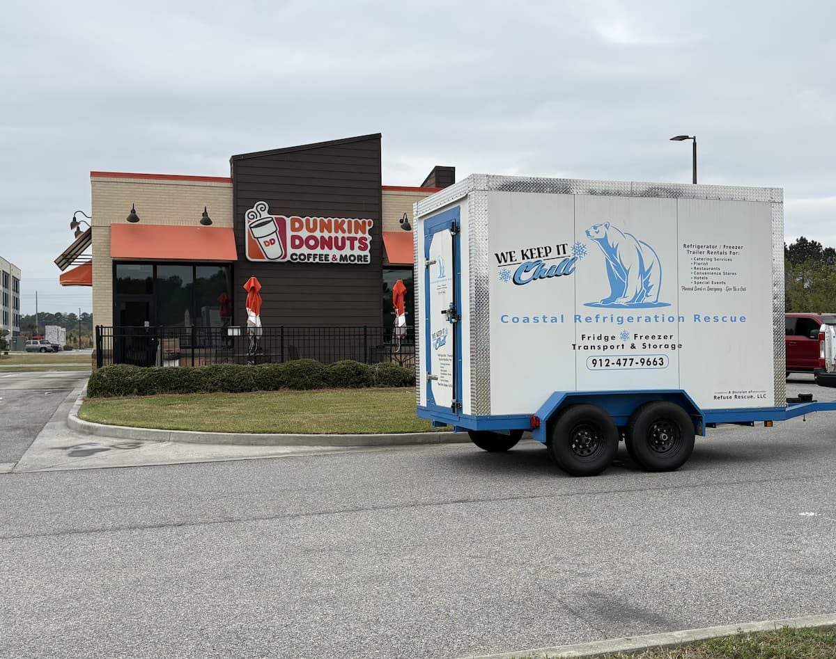 Coastal Refrigeration Rescue trailer on-site at a commercial customer Coastal Refrigeration Rescue trailer parked at a Dunkin' Donuts location in Georgia, branded with polar bear logo